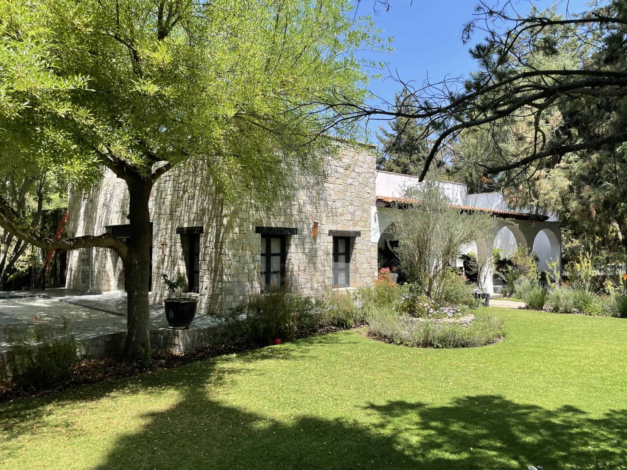 Beautiful countryside villa with lush garden and stone exterior, perfect for peaceful living or vaca.