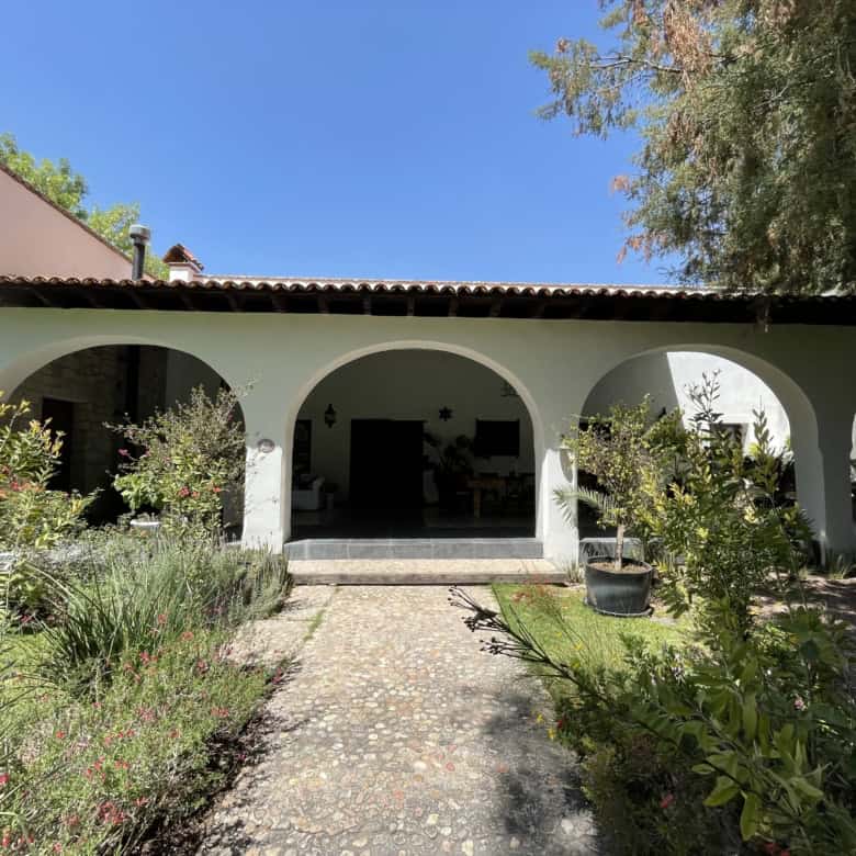 Spanish villa with arches and lush garden for sale.