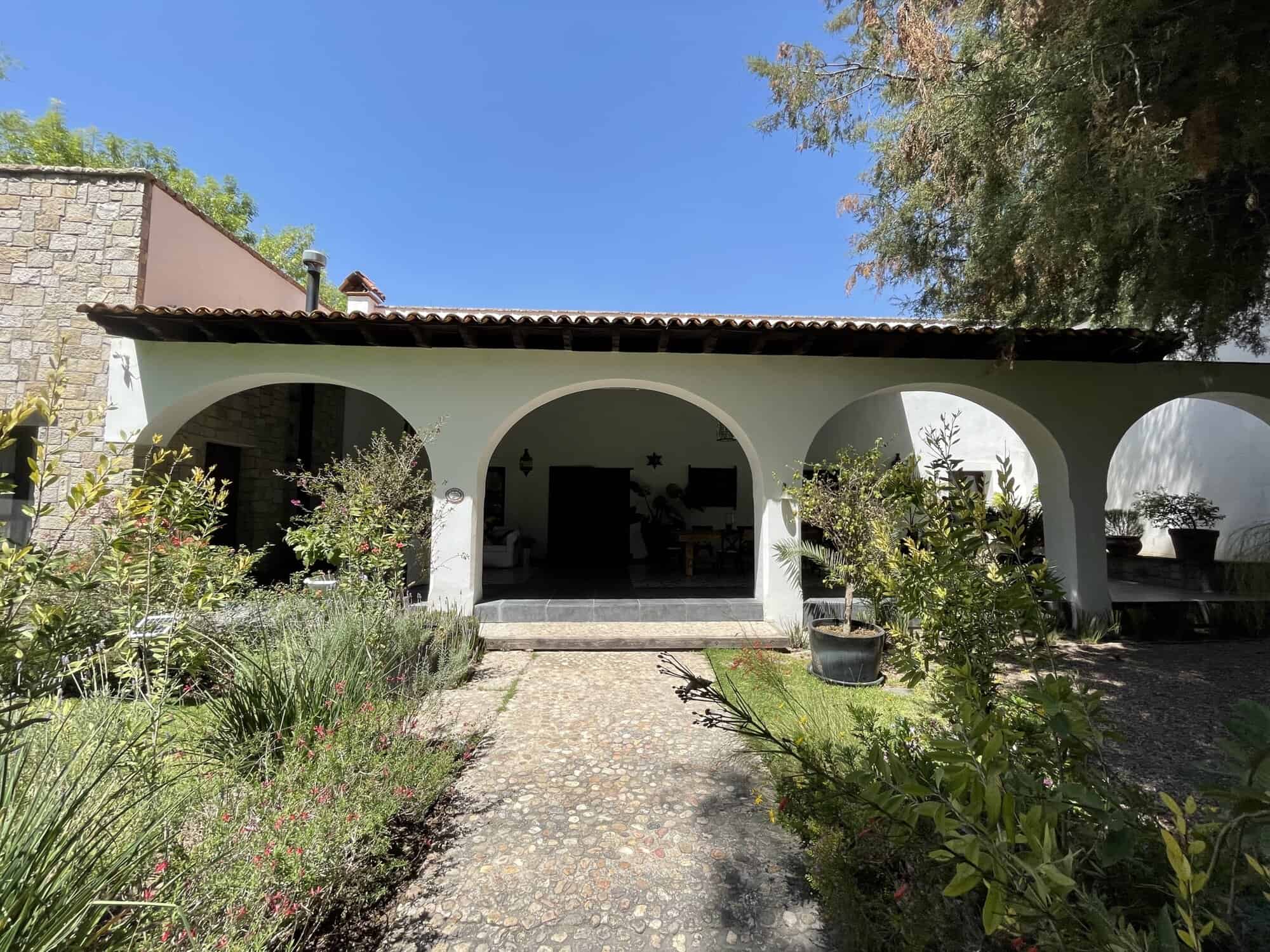 Spanish villa with arches and lush garden for sale.