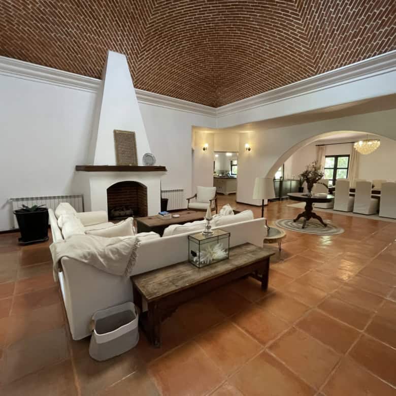 Spacious living room featuring a high vaulted ceiling, fireplace, and elegant decor for comfortable.