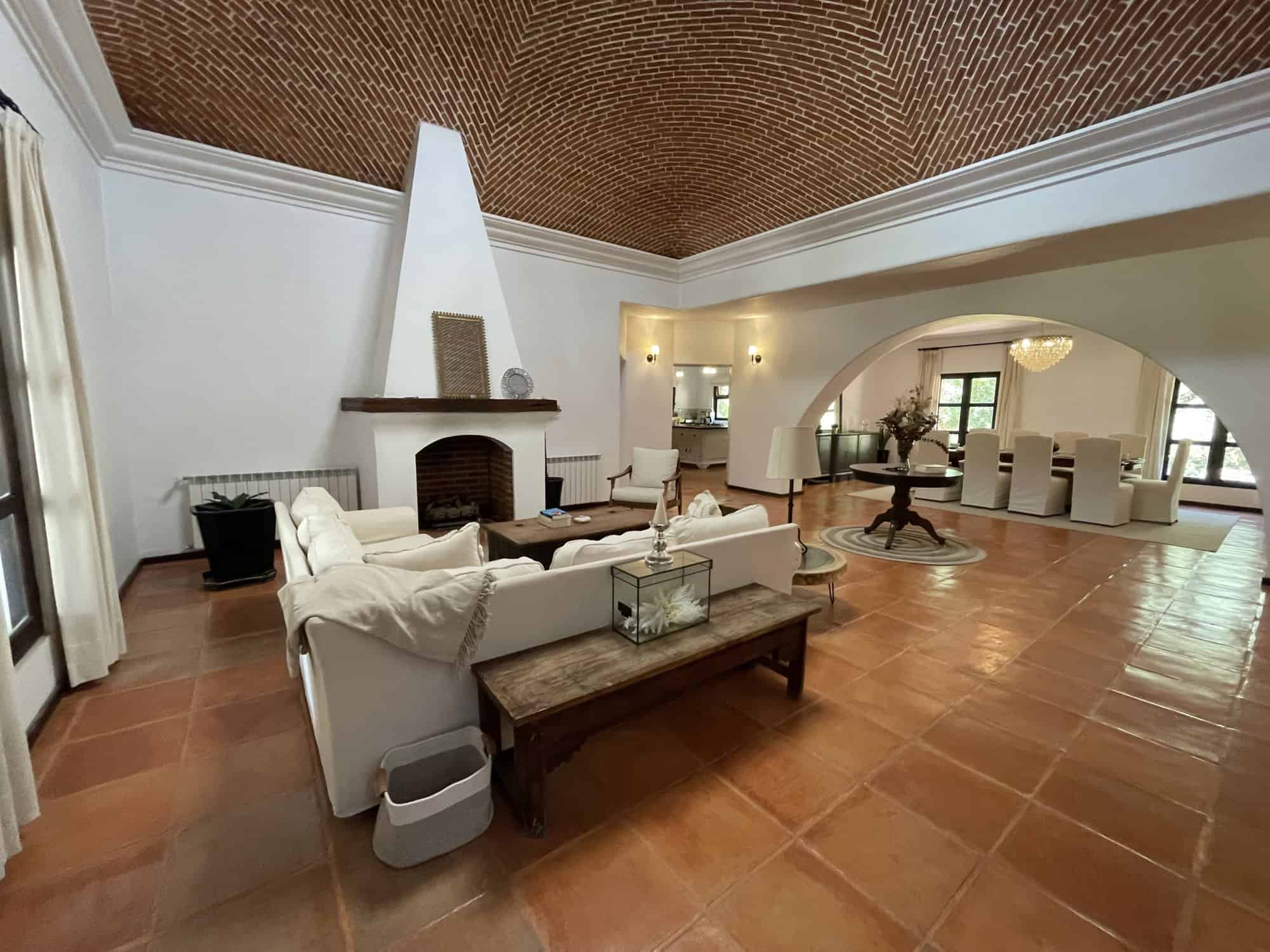 Spacious living room featuring a high vaulted ceiling, fireplace, and elegant decor for comfortable.