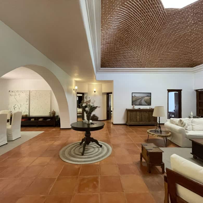 Spacious living room featuring high ceilings, elegant furniture, and modern decor for a luxurious ho.