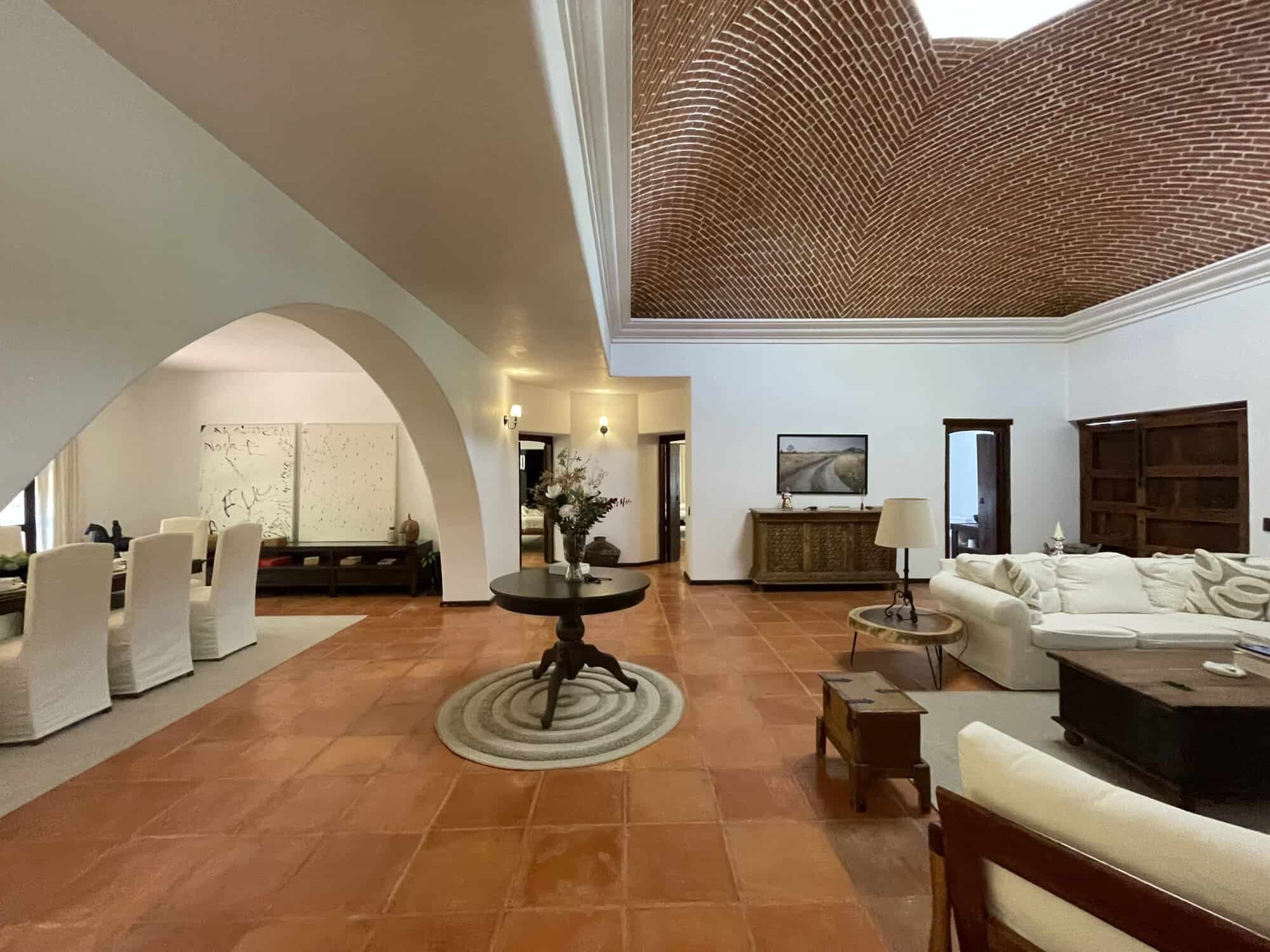 Spacious living room featuring high ceilings, elegant furniture, and modern decor for a luxurious ho.