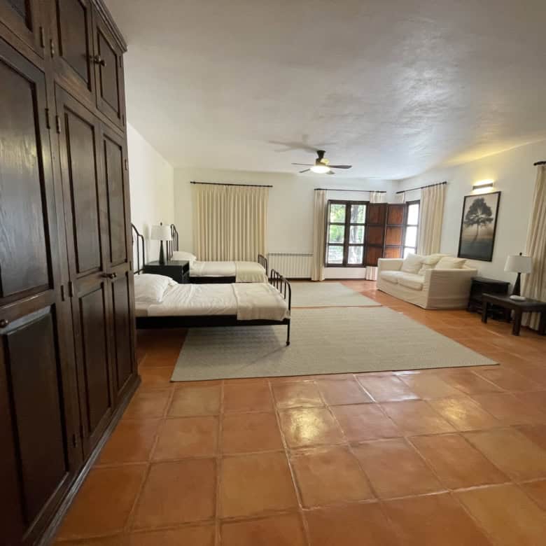 Bright and airy living space with large windows and comfortable seating. Perfect for relaxing or ent.