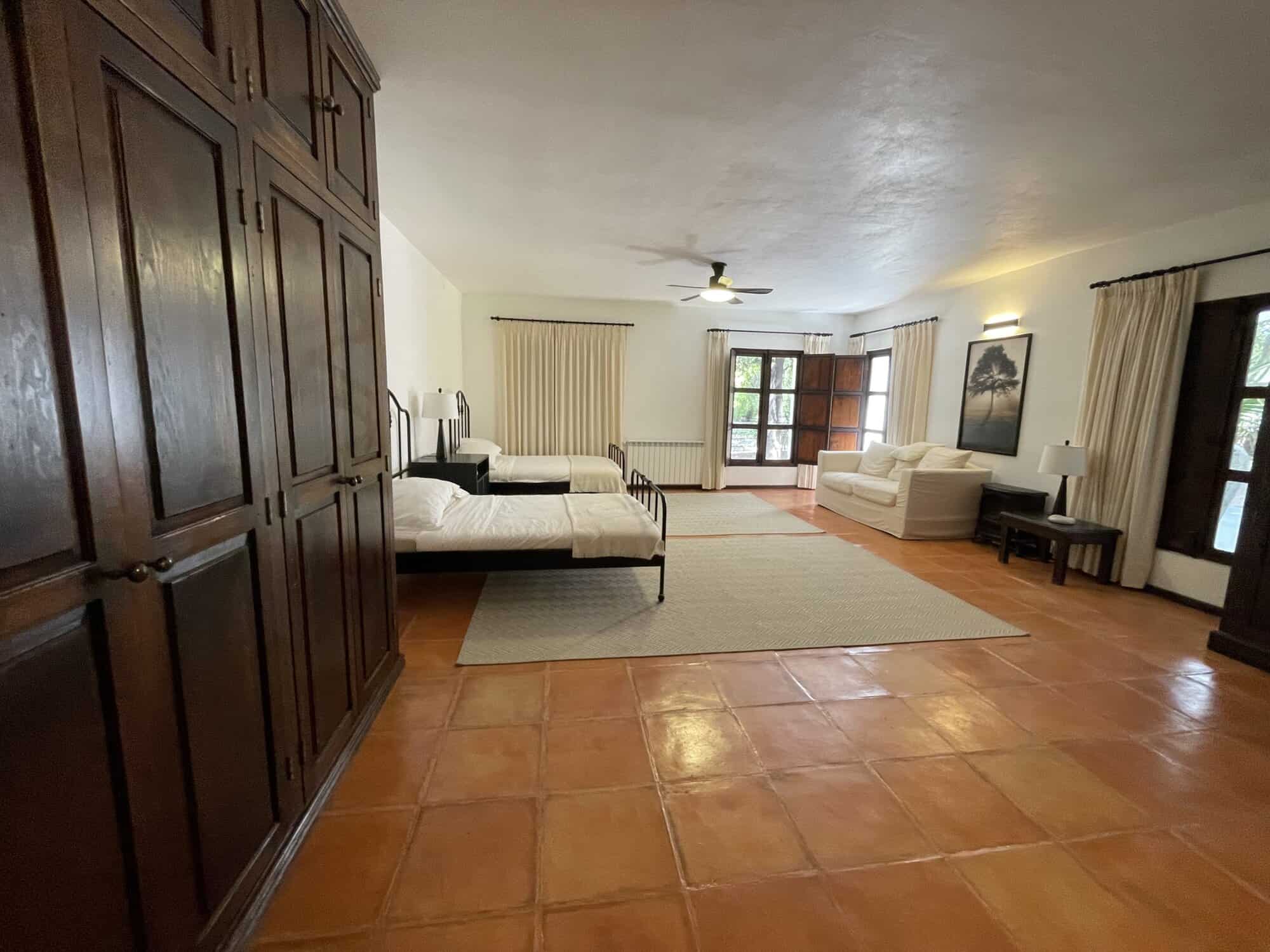 Bright and airy living space with large windows and comfortable seating. Perfect for relaxing or ent.