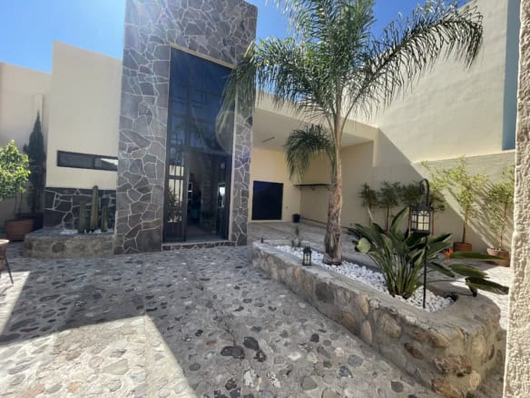 Modern villa with tropical garden, palm trees, and stylish exterior design.