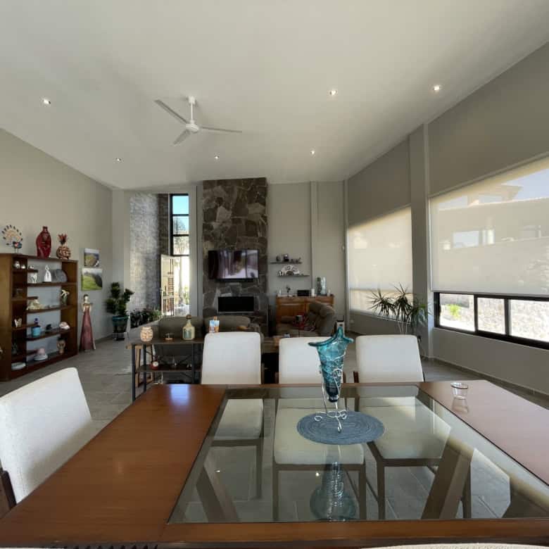 Spacious living room featuring large windows, modern furniture, and a cozy fireplace, perfect for re.