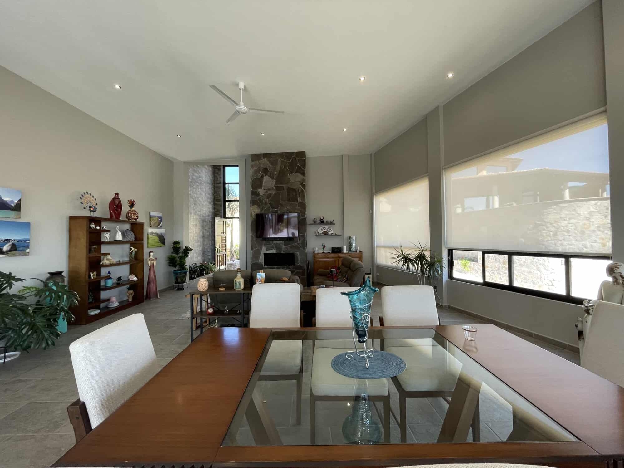 Spacious living room featuring large windows, modern furniture, and a cozy fireplace, perfect for re.