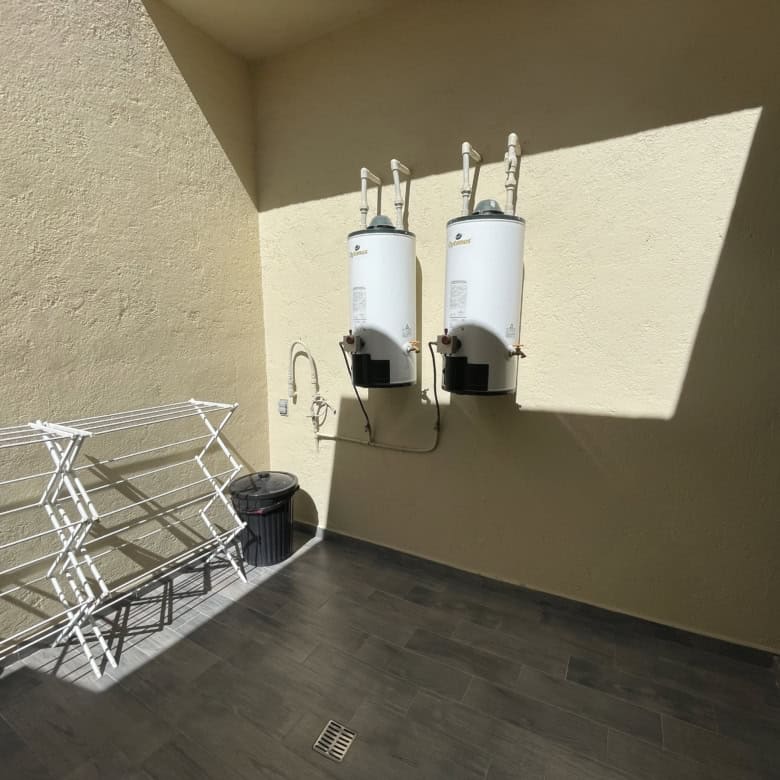 Water heater units on exterior wall of property.