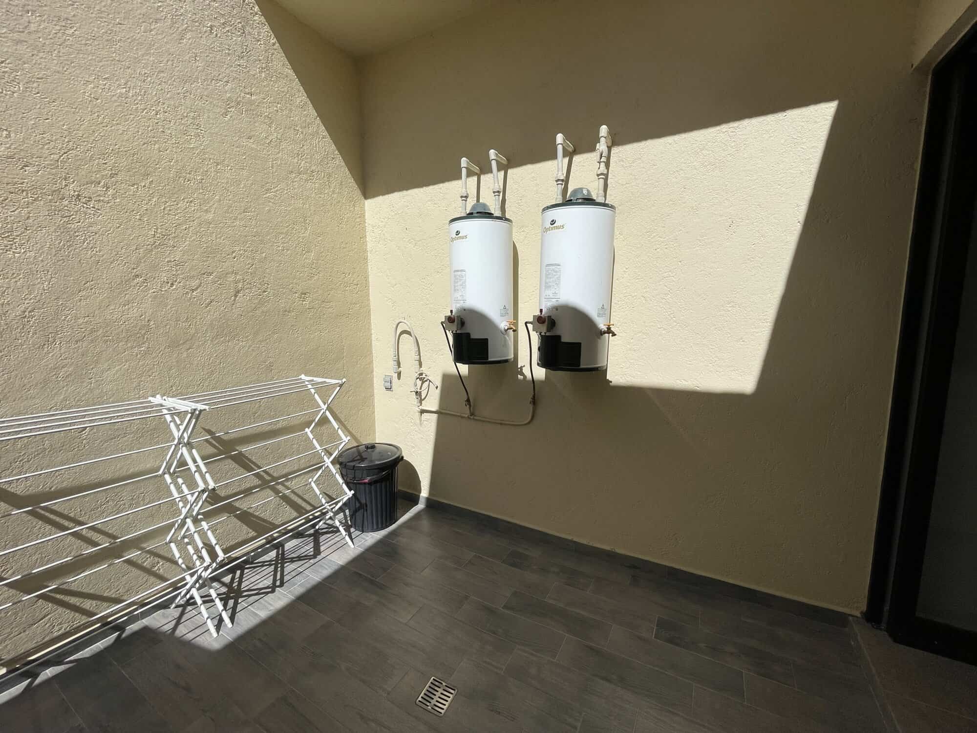 Water heater units on exterior wall of property.