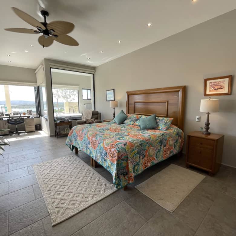 Modern bedroom with balcony and sea view in a coastal property.