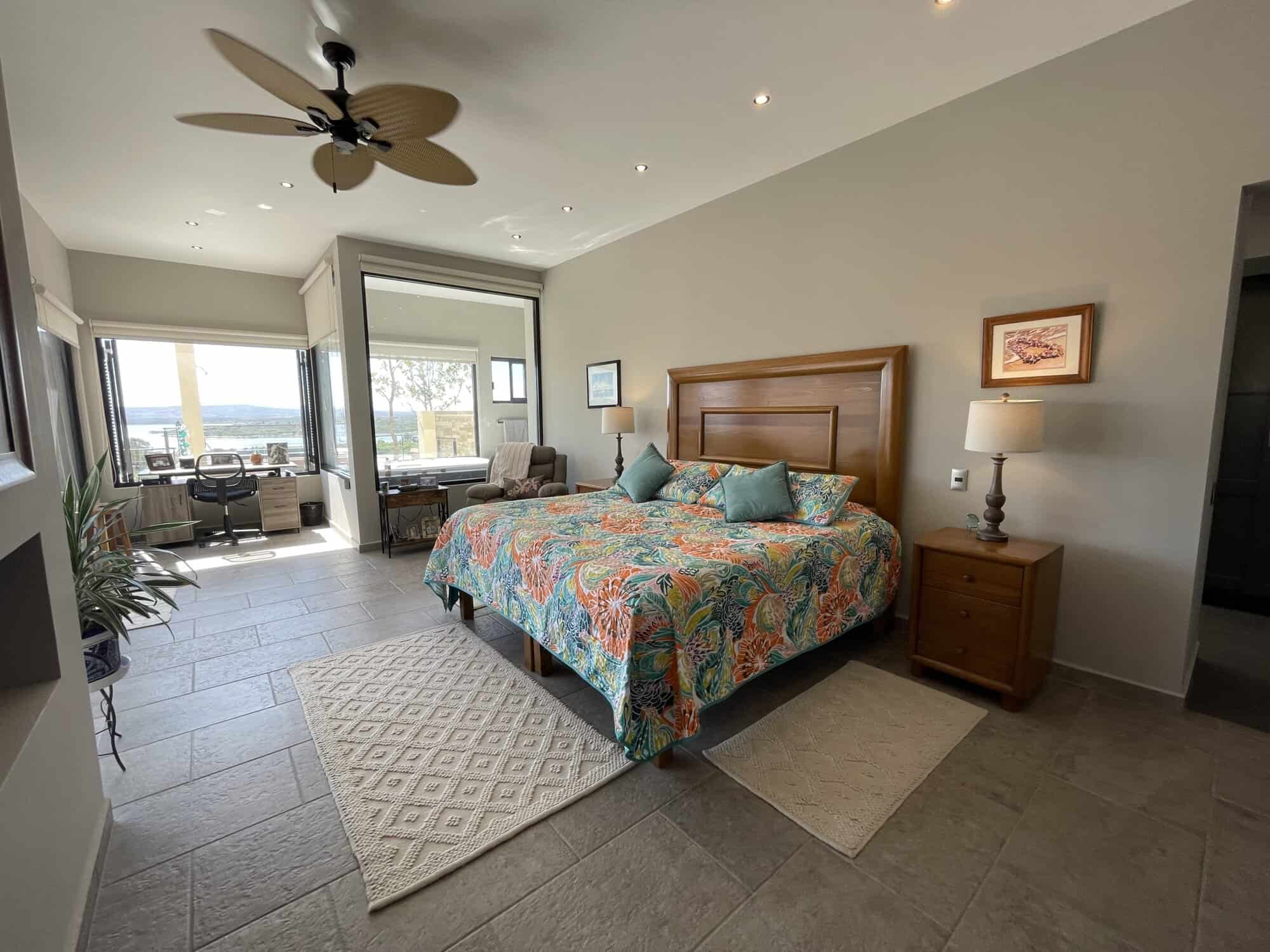 Modern bedroom with balcony and sea view in a coastal property.