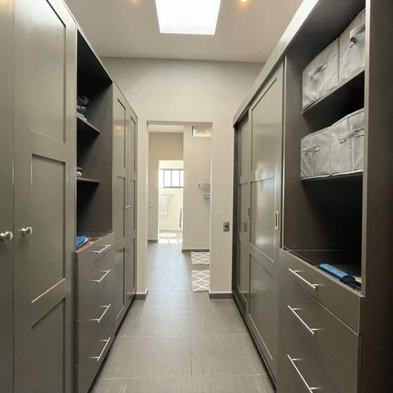 Modern walk-in closet with ample storage space and organized shelving.