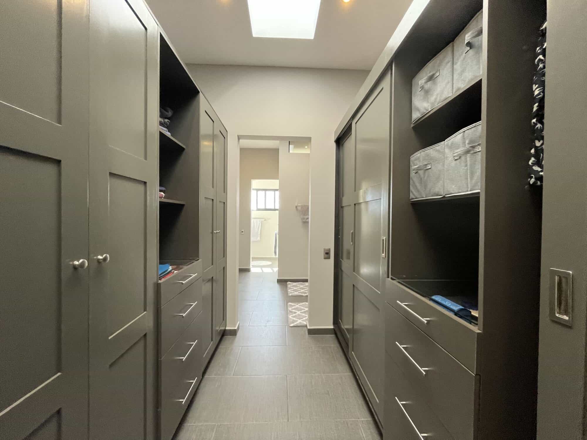 Modern walk-in closet with ample storage space and organized shelving.