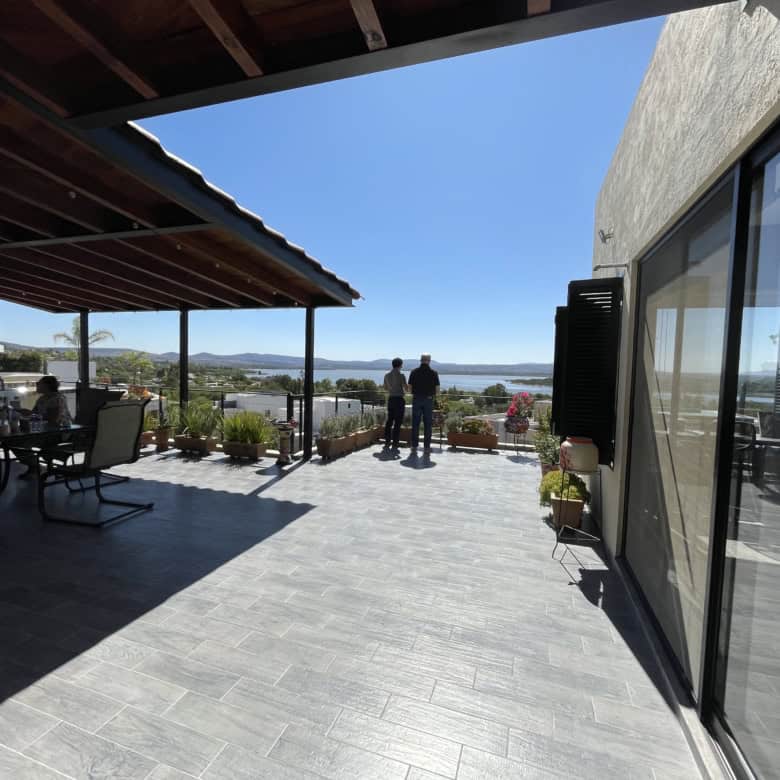 Modern waterfront terrace with sea view and outdoor seating area.