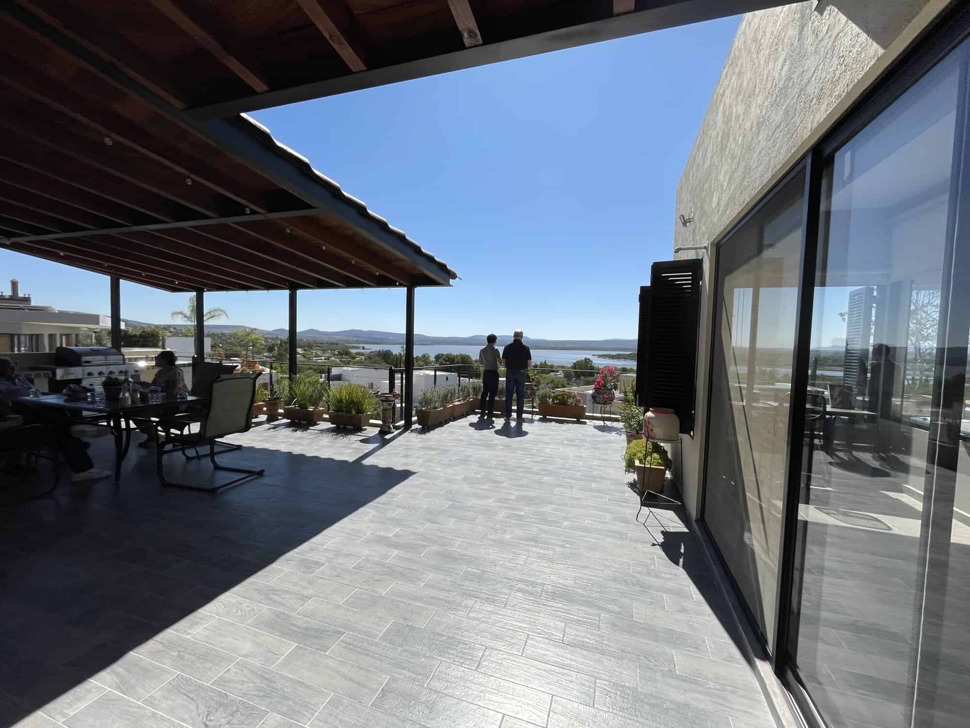Modern waterfront terrace with sea view and outdoor seating area.