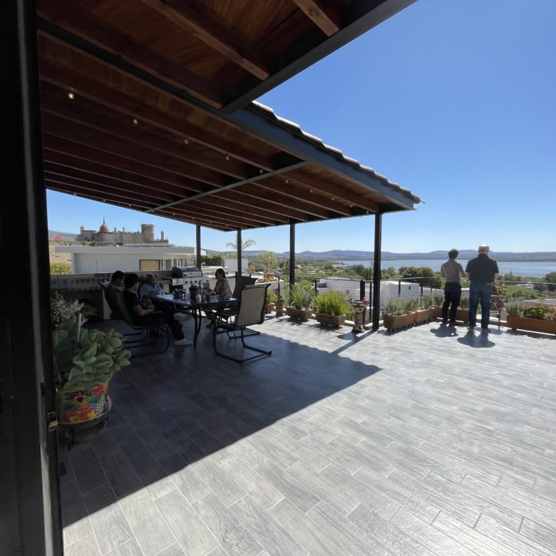 Outdoor terrace with water views and seating area.
