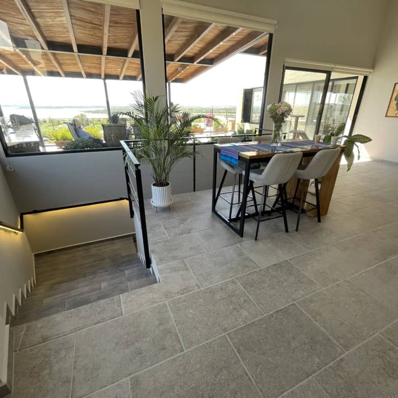 Modern interior with large windows and balcony view, bright and spacious living area with stylish de.