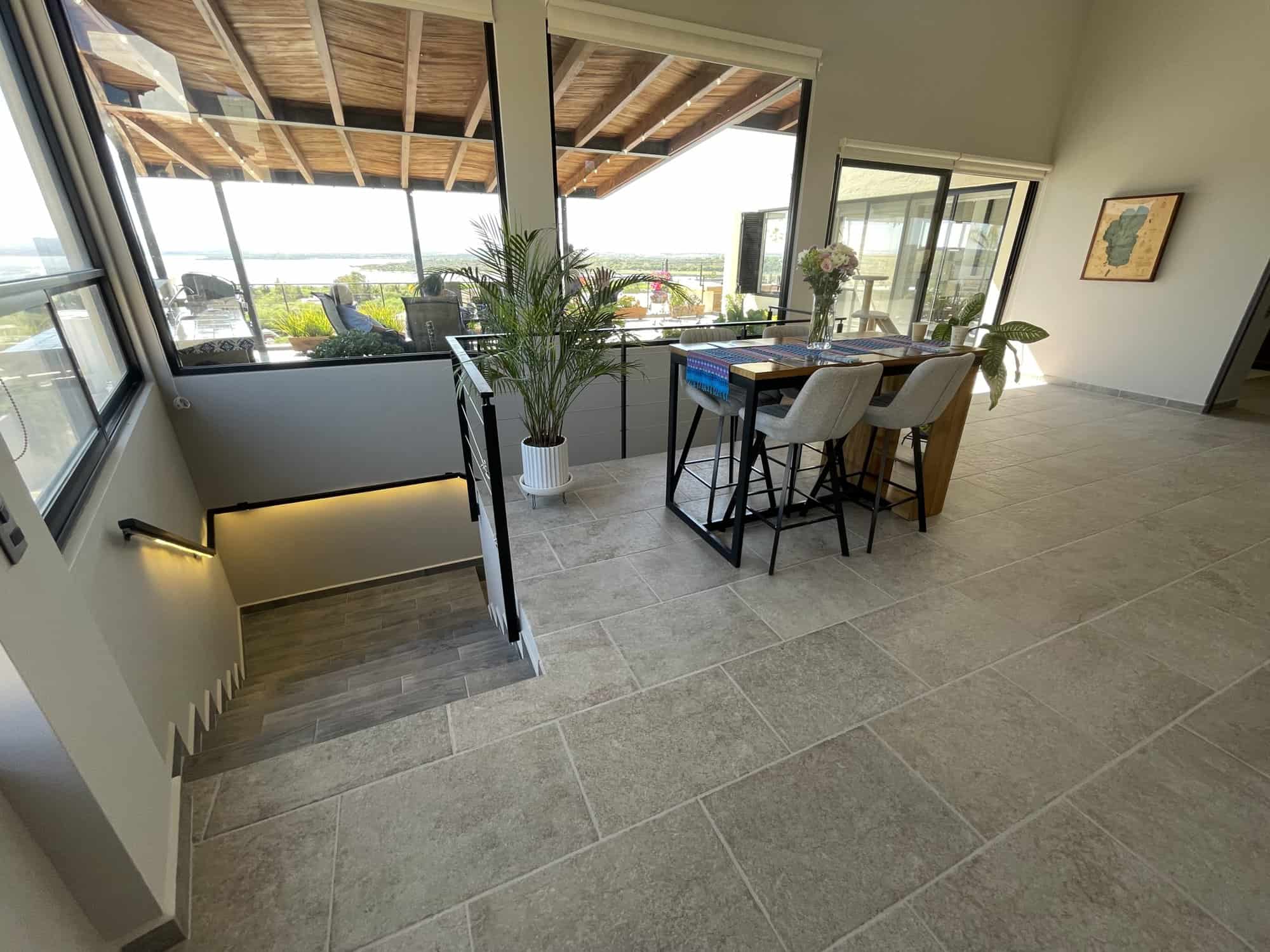 Modern interior with large windows and balcony view, bright and spacious living area with stylish de.