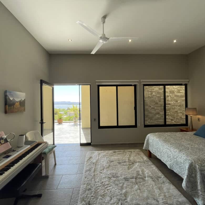 Modern bedroom with balcony and scenic view of the outdoors.