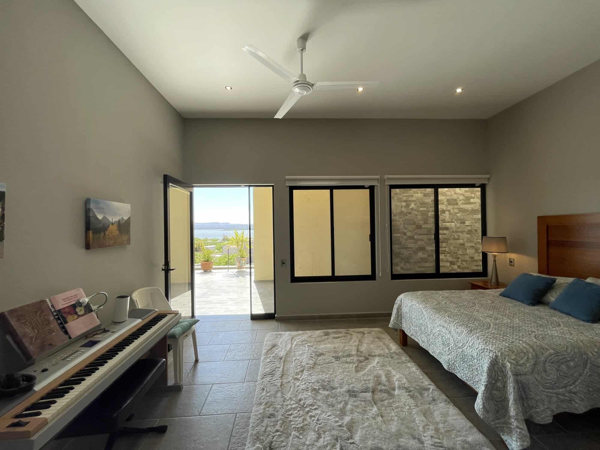 Modern bedroom with balcony and scenic view of the outdoors.