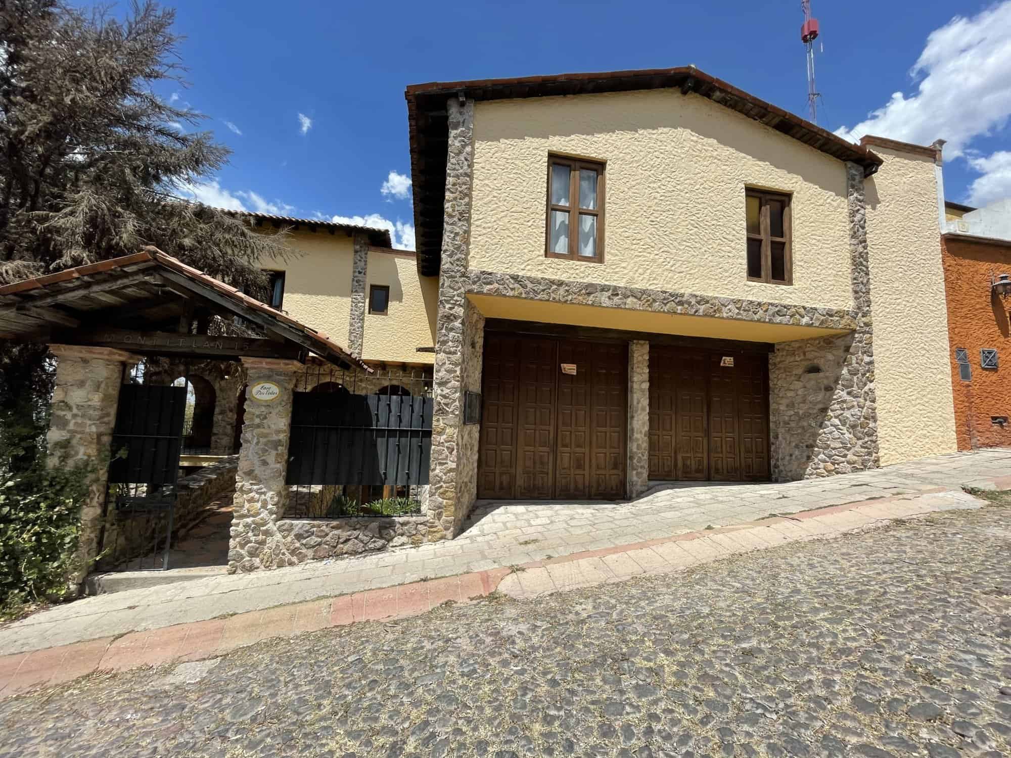 Beautiful two-story house with a spacious garage and rustic stone accents. Perfect for comfortable l.
