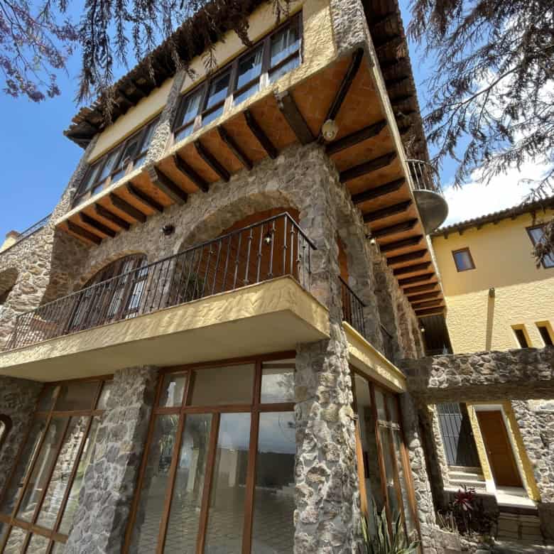 Cozy mountain house featuring stone walls and wooden accents, perfect for a peaceful getaway.