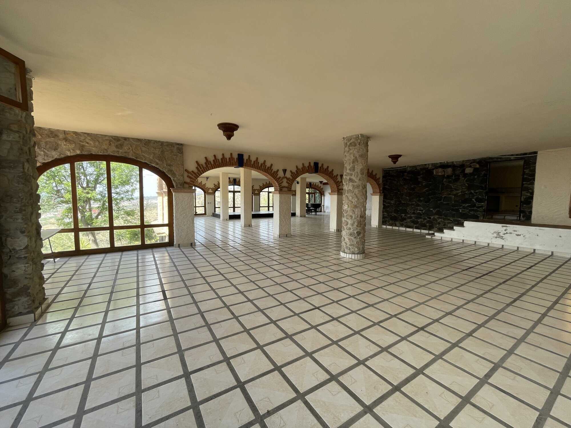 Spacious interior with large windows, tiled flooring, and stone accents, ideal for a luxurious home.