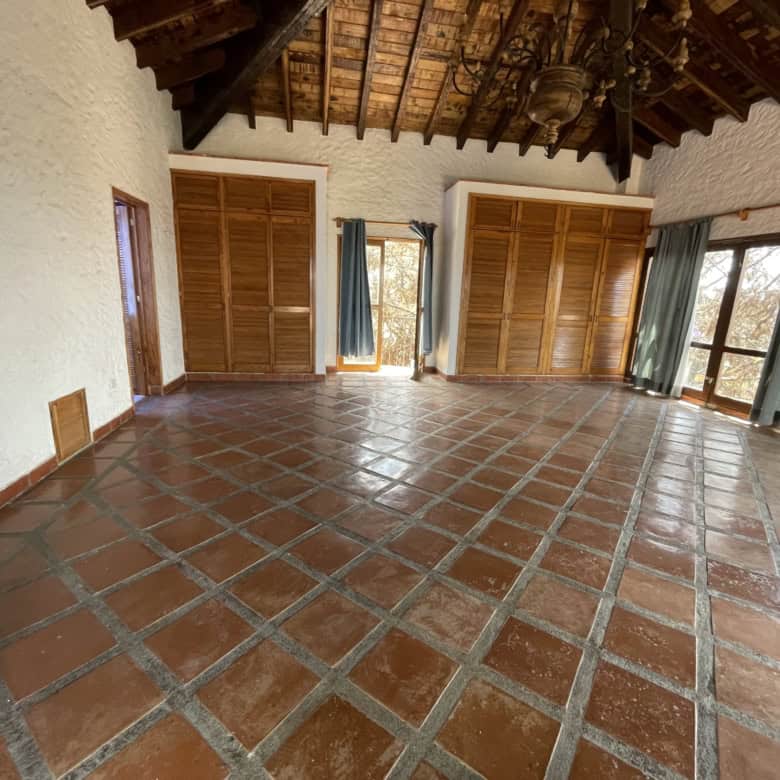 Bright and airy living space with terracotta tiled floors and wooden shutters, offering stunning nat.