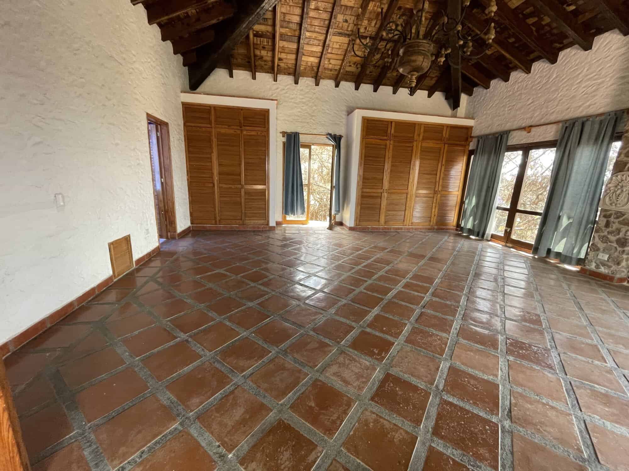 Bright and airy living space with terracotta tiled floors and wooden shutters, offering stunning nat.