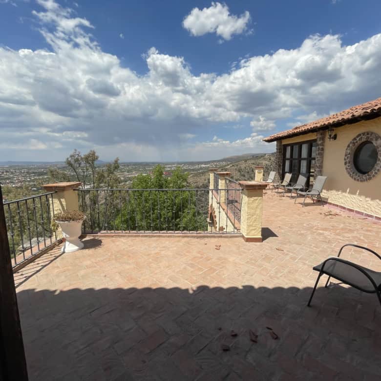 Luxury terrace with scenic city views and outdoor seating.