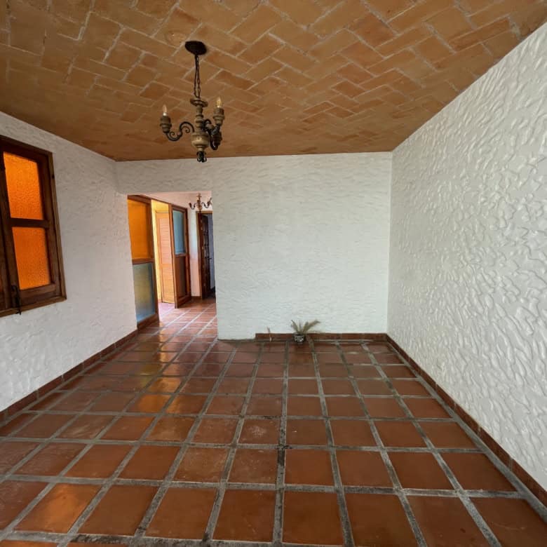 Traditional Spanish-style interior patio with terracotta tiles and colorful stained glass windows.