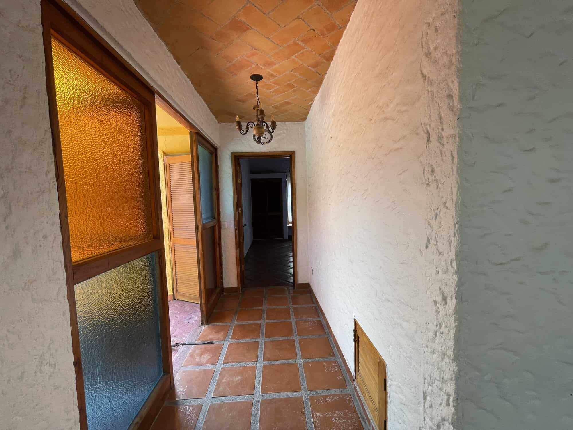 Balcony corridor with terracotta tiles and rustic decor, perfect for enjoying outdoor views and rela.