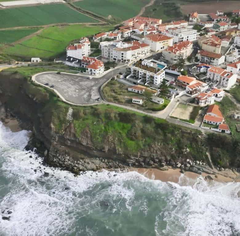 Aerial view of Pôr do Sol in Sao Bernardino, Portugal, showcasing coastal cliffs, colorful houses,.