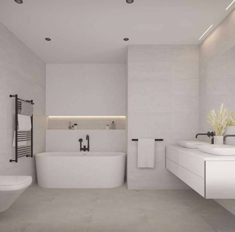 Contemporary bathroom featuring a bathtub, wall-mounted toilet, and stylish sink in a bright, modern.
