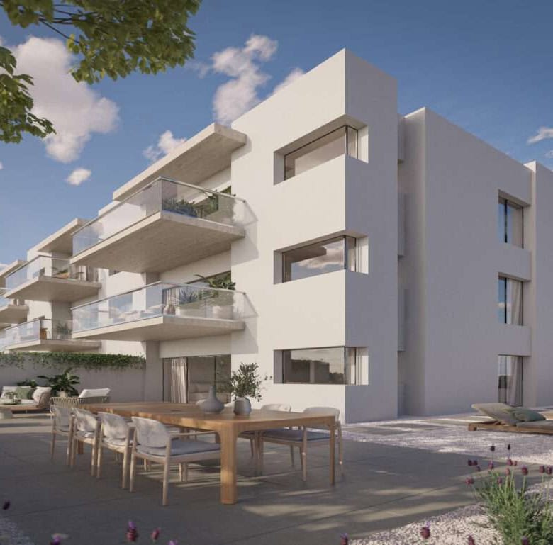 Modern white apartment building in Sao Bernardino, Portugal with spacious balconies and outdoor seat.