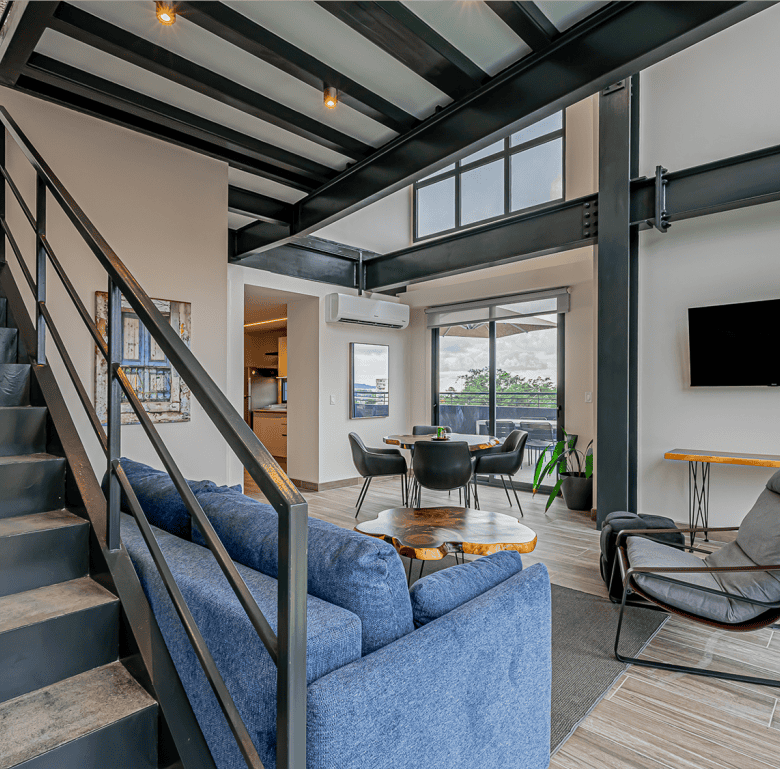 Contemporary apartment in Panama City with spacious living area, large windows, and modern decor.