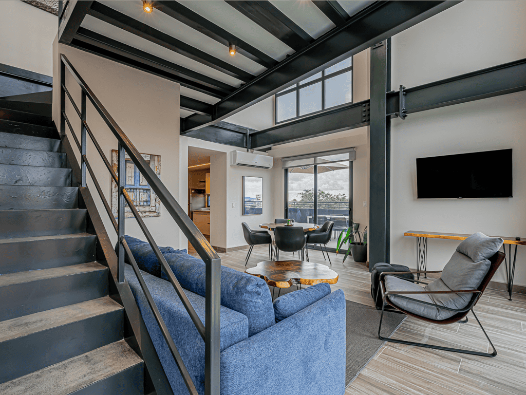 Contemporary apartment in Panama City with spacious living area, large windows, and modern decor.