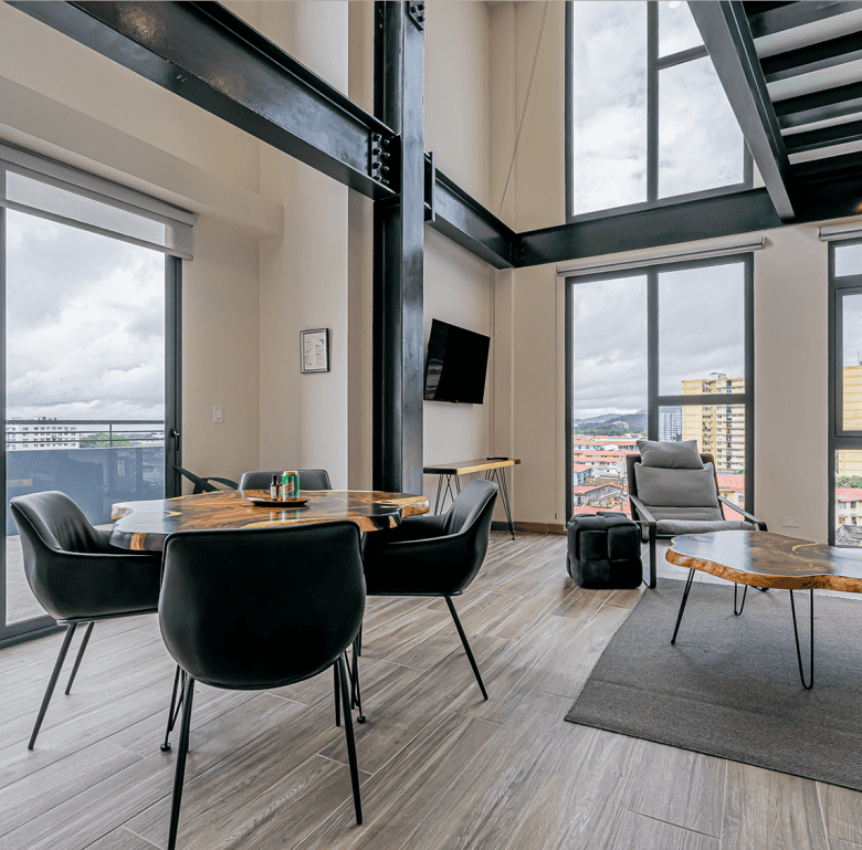 Interior view of a modern apartment in Panama City with large windows and Casco View.