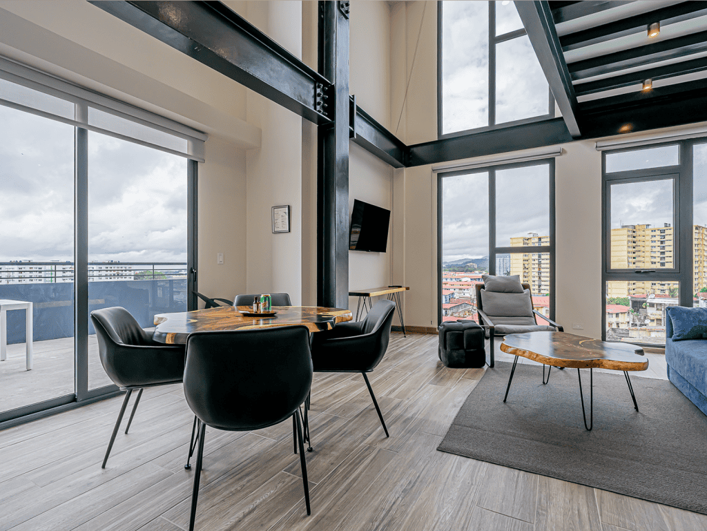 Interior view of a modern apartment in Panama City with large windows and Casco View.