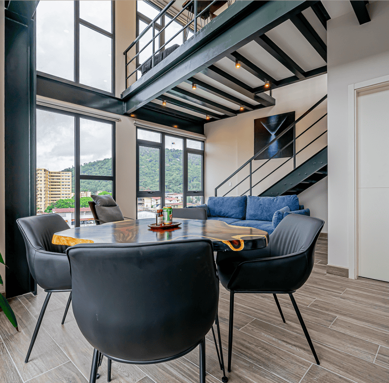 Stylish living space in Panama City with high ceilings, large windows, and contemporary decor.