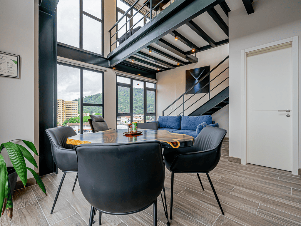 Stylish living space in Panama City with high ceilings, large windows, and contemporary decor.