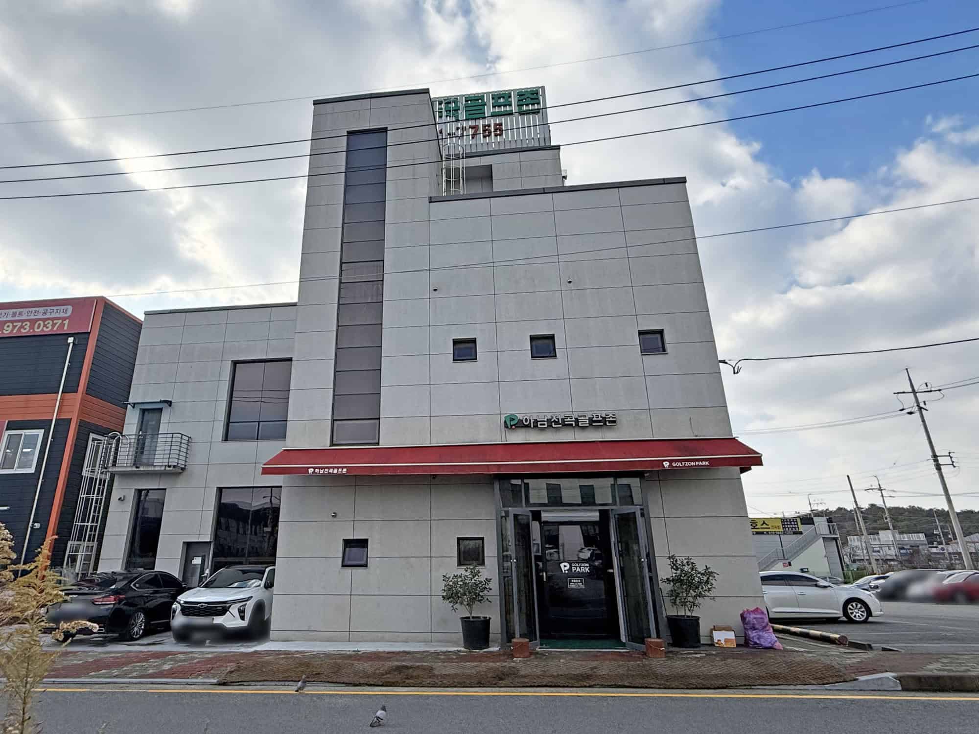 Modern commercial building with a sleek design, located in a busy business area.