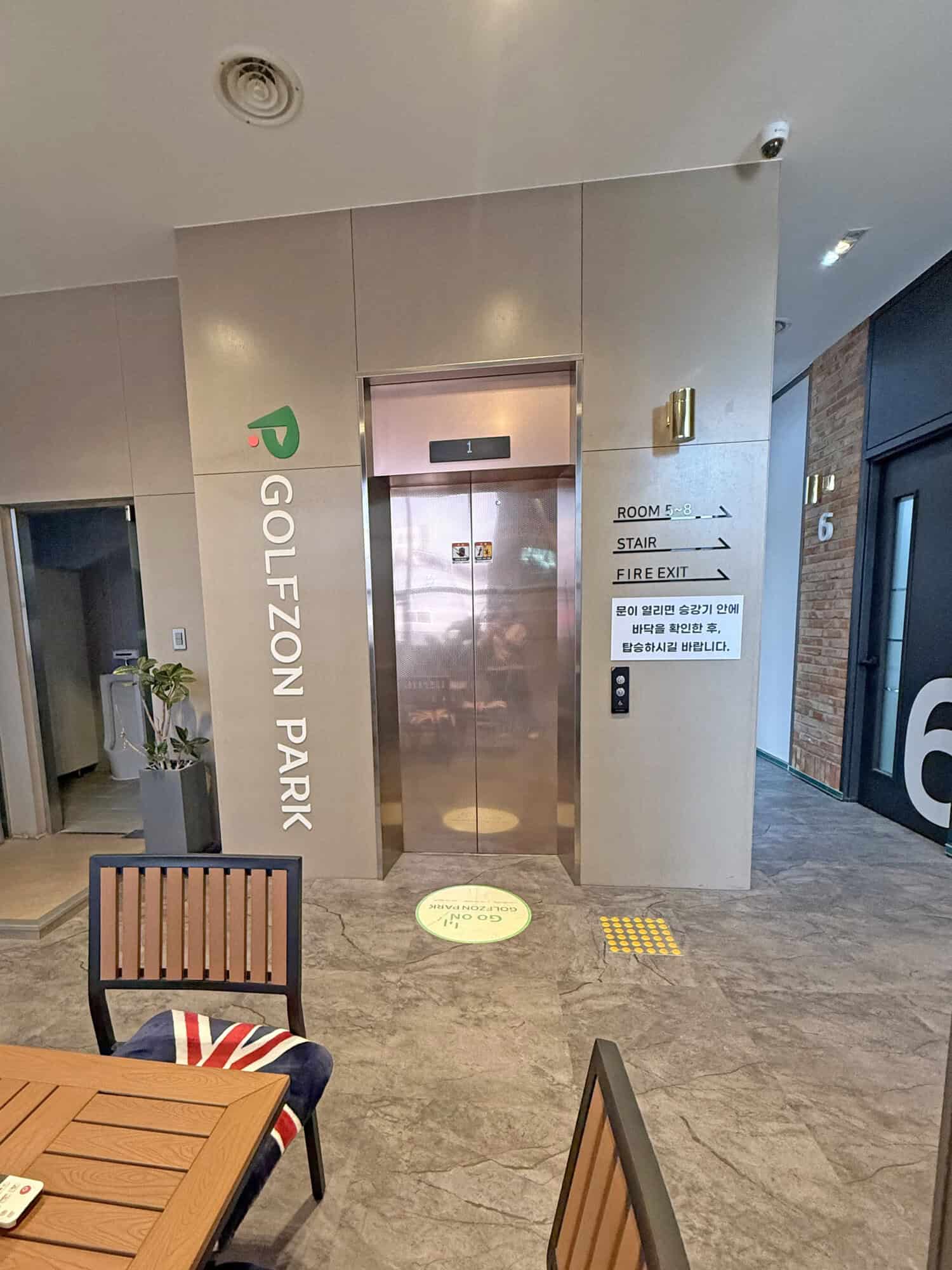 Elevator doors with signage for rooms, stairs, and fire exit.