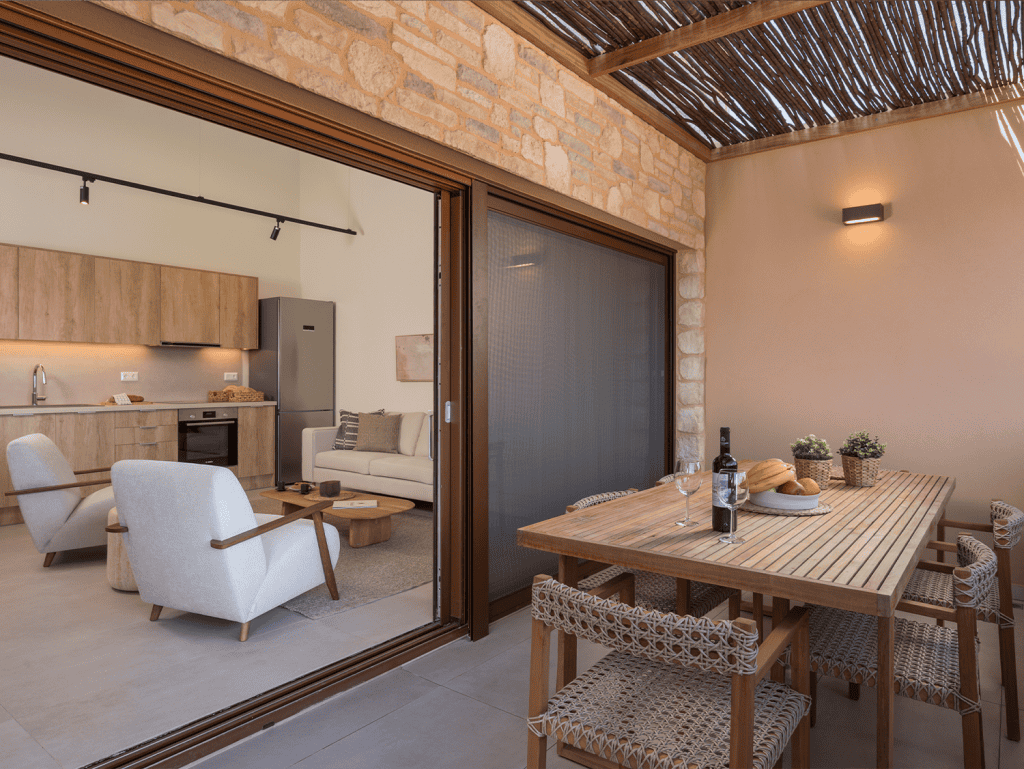 Modern living space with outdoor dining area in Maleme Residences, Crete.