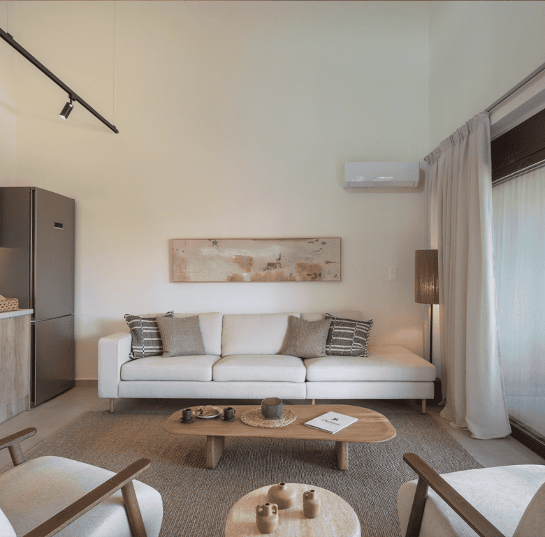 Spacious living room in Maleme Residences, Crete, Greece, featuring contemporary furniture and natur.