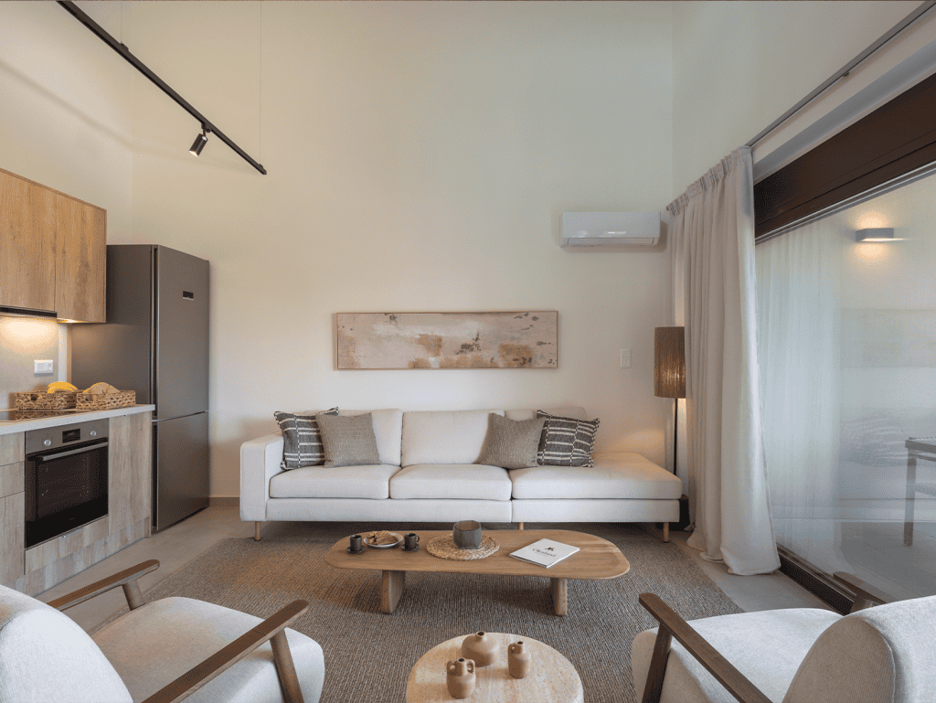 Spacious living room in Maleme Residences, Crete, Greece, featuring contemporary furniture and natur.