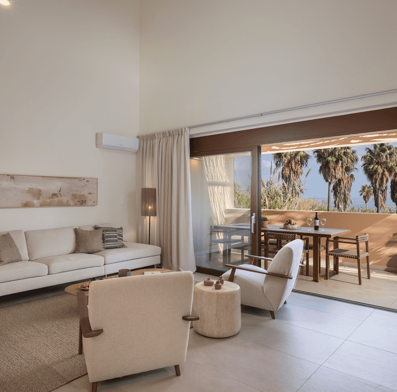 Spacious living room with modern furniture and large glass doors opening to a balcony.