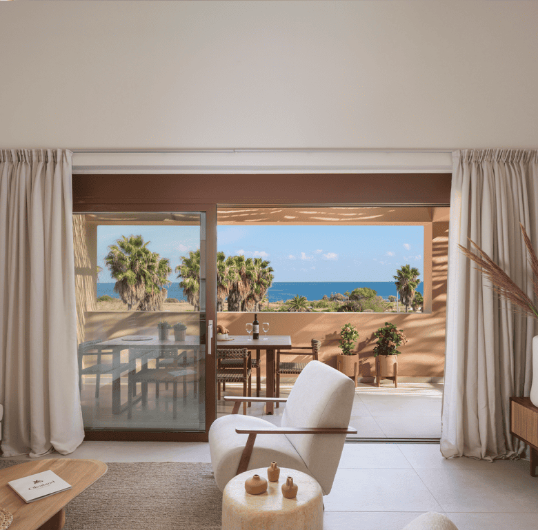 Sea view living room with balcony access at Maleme Residences, Crete, Greece.