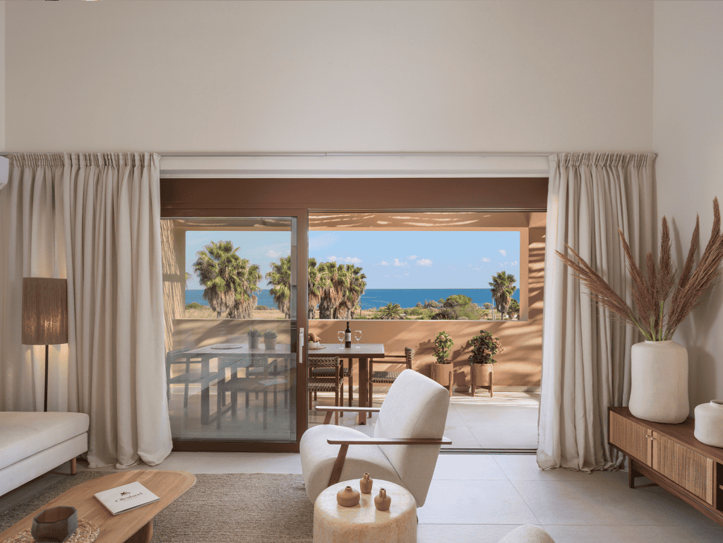 Sea view living room with balcony access at Maleme Residences, Crete, Greece.